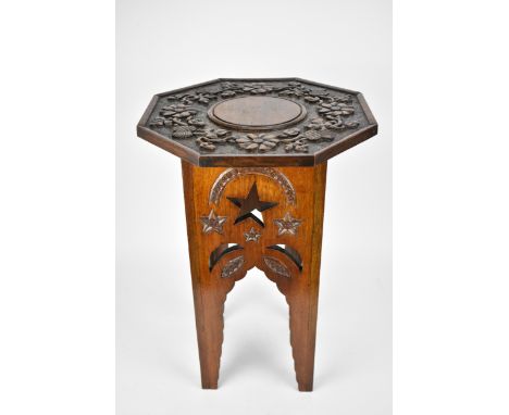 A late 19th century Anglo Indian Moorish octagonal and carved table, the to deeply carved with flowers, thistle and acorns, t