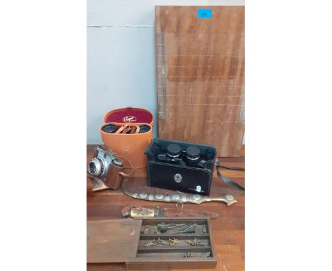 A vintage lot to include binoculars, daggers, a Paxina camera, and lead soldiers Location: 