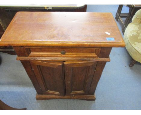 An oak refectory style side cabinet with single drawer above twin cupboard doors, single shelf interior, standing on bracket 