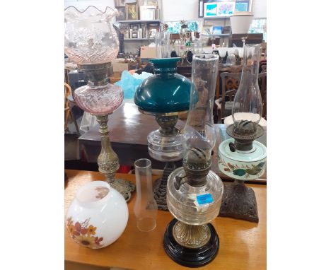 Four Victorian oil lamps with 4 glass funnels, glass and ceramic reservoirs, and 3 shades one A/F Location: A2M 