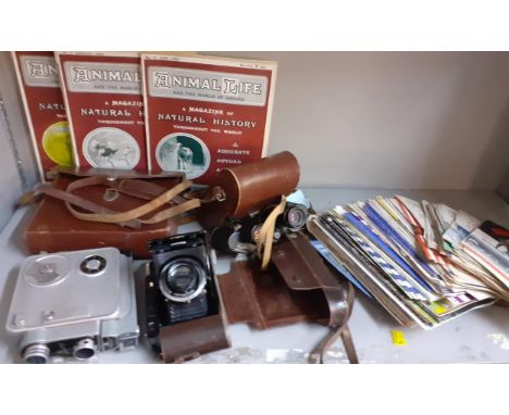 A mid 20th Century Admica 8 cinecamera, a Voiglander Besse camera, binoculars, vintage magazines and football programmes to i