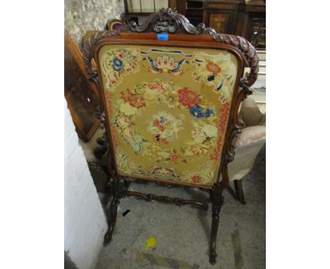 A carved Victorian mahogany fire screen with floral tapestry panel 129cm x 72cm A/F Location: 