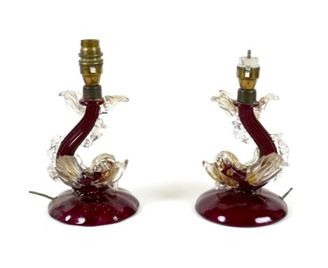 A pair of vintage Murano cranberry and clear glass table lamp bases, circa 1950, each modelled as a dolphin with gilt highlig