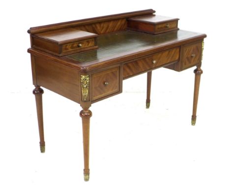 A French early to mid 20th century mahogany veneered writing desk, with green leather writing surface, with five drawers and 