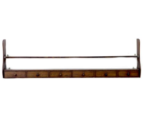 A 19th century mahogany plate rack, with six spice drawers below, 176 by 17 by 56cm high. 