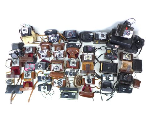 A collection of retro cameras and accessories, including two Polaroid cameras, a Super Swinger Land Camera with case and a Su