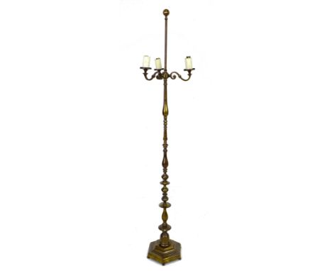 An early to mid 20th century brass standard lamp, with three S shaped branches, the knopped column on hexagonal base with bun