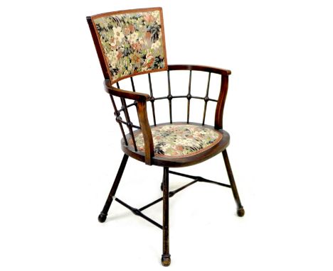 An Arts &amp; Crafts bobbin armchair, with floral upholstered seat and back, raised on splayed legs with ball ends, joined by