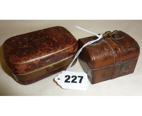 Two leather-covered travel inkwells, one in the form of a miniature trunk