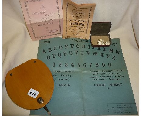 Rare 1920s card Ouija board with wooden planchette and directions leaflet, together with two faceted numbered glass balls and