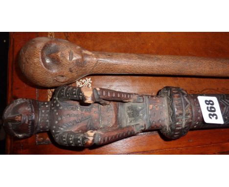 Tribal Art: African hardwood walking stick with carved head handle and glass eye and another African walking stick with carve