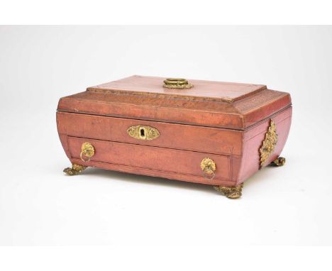 A William IV red calf, covered work box, rectangular with a caddy top, the canted top with stamped decoration in the form of 