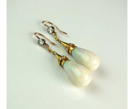 A pair of late 19th century opal and diamond ear pendants, each designed as a polished opal drop mounted in yellow metal set 