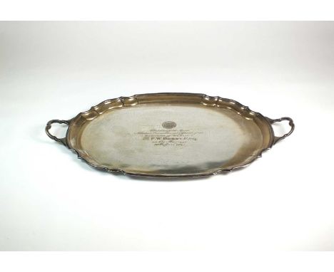 A large two handled silver presentation tray, James Deakin &amp; Sons, Sheffield 1924, of shaped oval form, the centre engrav