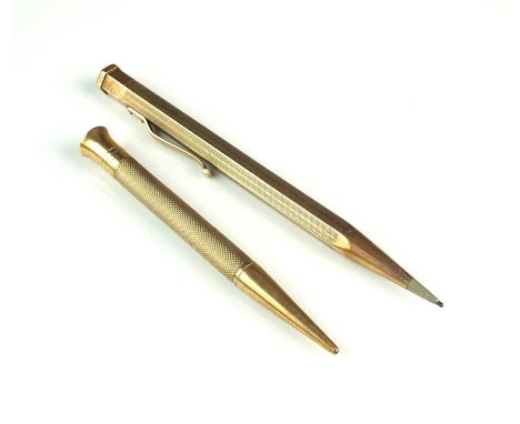 A 9ct gold retractable pencil, Johnson, Matthey &amp; Co, London 1957, of faceted engine turned form, 12cm long, together wit