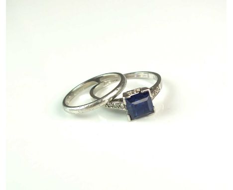 An Art Deco single stone sapphire ring, the square faceted sapphire claw set in white metal to diamond set soulders and white