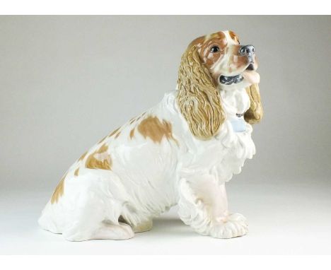 A large Meissen porcelain model of a cocker spanielafter a design by Erich Hosel (1869-1953)modelled seated with a brown and 