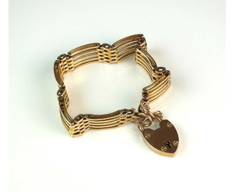 A yellow metal five bar gate link bracelet, with heart shaped padlock clasp stamped '9ct' 'J.G &amp; S', weight approx 25gCla