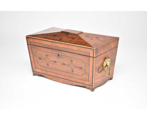 A Regency mahogany, sarcophagus form tea caddy, inlaid with boxwood and ebony stringing and lozenge-form motifs with dot and 