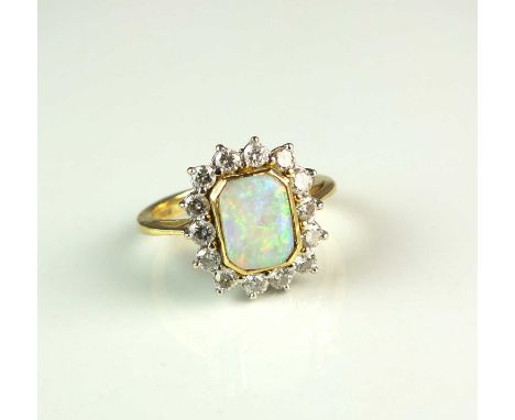 An 18ct gold opal and diamond cluster ring, designed as a central canted rectangular opal cabochon plaque collet set in yello