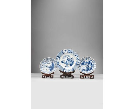 THREE CHINESE BLUE AND WHITE DISHESKANGXI 1662-1722Comprising: a dish painted with landscape scenes of ladies, scholars and b