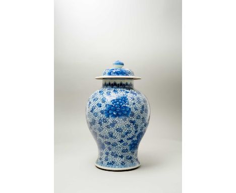 A CHINESE BLUE AND WHITE BALUSTER VASE AND COVERKANGXI 1662-1722Painted with large peonies on a floral ground, 42.5cm. (2)Pro