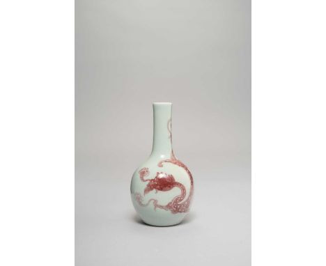 A SMALL CHINESE COPPER-RED 'CHILONG' BOTTLE VASE 18TH/19TH CENTURY  Painted with a sinuous dragon emitting streams of vapour,