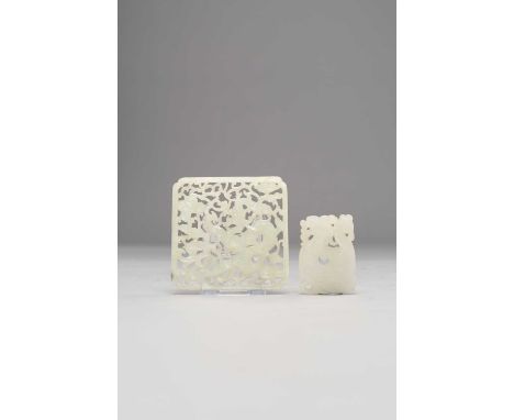TWO CHINESE WHITE JADE PLAQUES QING DYNASTYThe larger reticulated and carved with a dragon, the other a stylised rectangular 