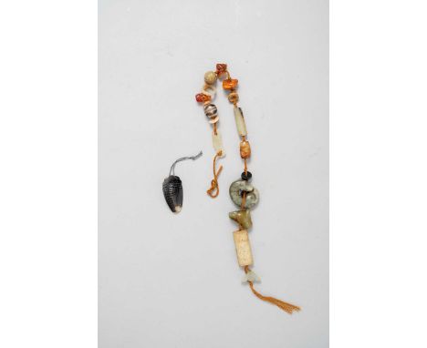 A GROUP OF CHINESE JADE, AMBER AND AGATE CARVINGS19TH AND 20TH CENTURYComprising: a string of various carvings including anim