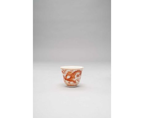 A CHINESE IRON-RED 'DRAGON' WINE CUP SIX CHARACTER TONGZHI MARK AND PERHAPS OF THE PERIODThe exterior painted with two stridi