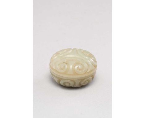 A CHINESE CELADON JADE CIRCULAR BOX AND COVER QING DYNASTY OR LATERCarved in imitation of lacquer, with guri motifs, 4.6cm. (