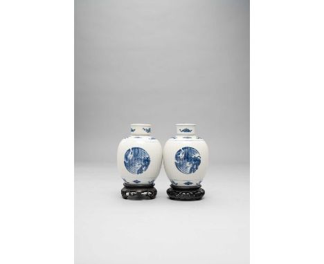 A PAIR OF CHINESE BLUE AND WHITE RIBBED OVOID JARS AND COVERSKANGXI 1662-1722Painted with phoenix roundels on the ribbed cent