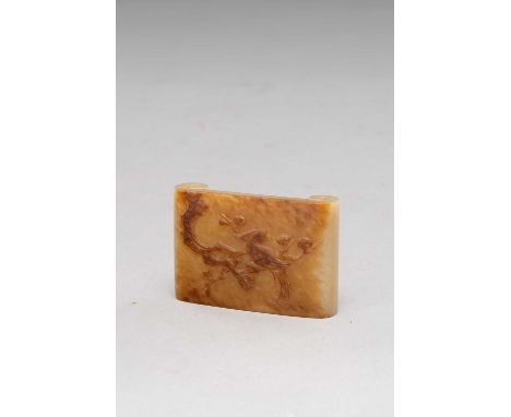 A CHINESE CELADON AND RUSSET JADE BRUSH REST QING DYNASTY OR LATERCarved with a bird perched on a gnarled prunus branch, the 