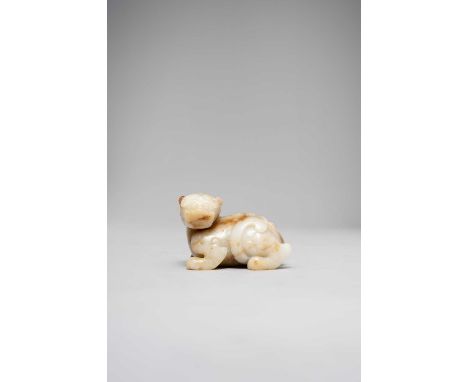 A CHINESE WHITE AND RUSSET JADE CARVING OF A PIXIU QING DYNASTY OR LATERThe mythical beast crouches down with its head turned