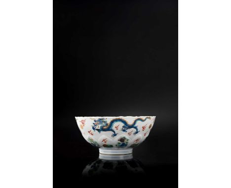 A CHINESE FAMILLE VERTE MOULDED 'DRAGON' BOWL KANGXI 1662-1722The exterior painted with three dragons in blue, turquoise and 