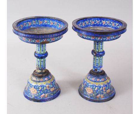 A PAIR OF 19TH CENTURY CHINESE CANTON ENAMEL CANDLE STICKS / STANDS, the stands decorated with floral decoration and ruyi hea