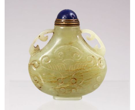 A GOOD CHINESE CARVED JADE SNUFF BOTTLE, carved with lotus decoration and twin handles, with lapiz stopper and spoon, 6cm.