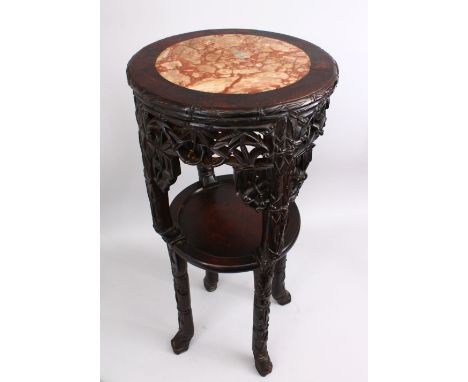A GOOD 19TH CENTURY CHINESE CARVED HARDWOOD MARBLE TOP STAND, the top inset with marble, the sides carved with panels of bamb