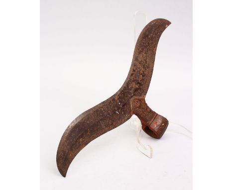 A LARGE 17TH / 18TH CENTURY SOUTH INDIAN STEEL AXE HEAD, with carved floral decoration, 32cm