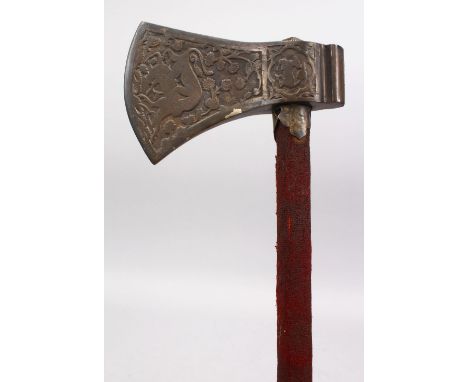 A FINE 18TH / 19TH CENTURY INDO PERSIAN ENGRAVED TABARZIN AXE, handle terminal has a concealed dagger, with animal engravings