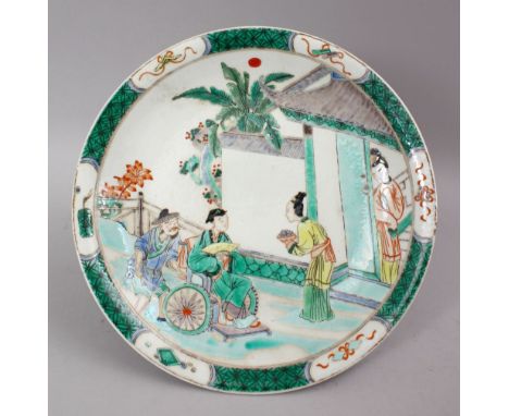 A CHINESE KANGXI STYLE FAMILLE VERTE PORCELAIN DISH, the dish depciting scenes of figures in garden settings, the verso with 