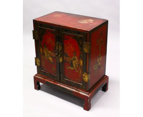 A 19TH CENTURY ORIENTAL / CHINESE RED LACQUER DECORATED TWO DOOR CHEST ON STAND, decorated with scenes of figures in a balcon