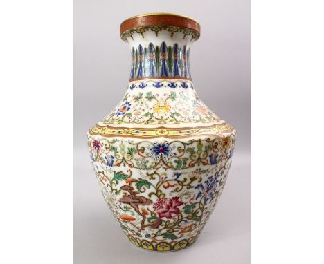 A GOOD CHINESE KANGXI STYLE FAMILLE ROSE PORCELAIN VASE, decorated with scenes of native flora amongst lotus and formal scrol