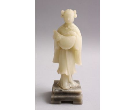 A GOOD CHINESE CARVED WHITE JADE FIGURE OF A GODDESS HOLDING A FISH, on a carved hardstone base, 18cm.