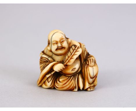 A LARGE JAPANESE MEIJI PERIOD CARVED IVORY NETSUKE OF A HOTEI,  in a seated position, holding a uchiwa fan, himotoshi formed 