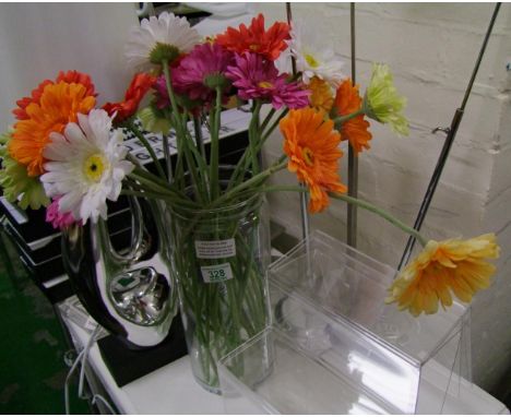 A mixed collection of retail counter top display items: together a modern table lamp, ornament, vase and flowers and a quanti