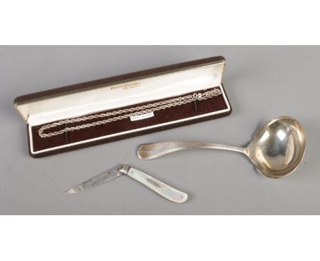 A Reed &amp; Barton sterling spoon (61g) along with a silver chain and silver bladed fruit knife.  Chip to mother of pearl sc