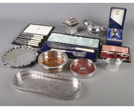 A quantity of silver plate. Includes lion mask handle tea caddy, tray, wine bottle coasters, Mappin &amp; Webb cased flatware