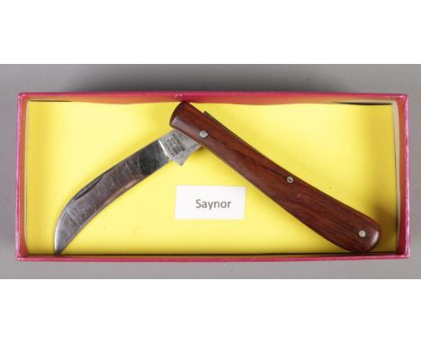 A folding pruning knife by Saynor, Sheffield. With hardwood scales.  