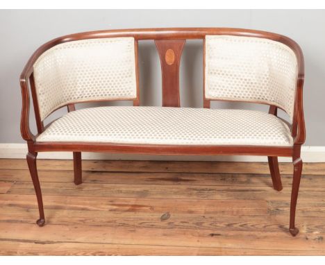 A mahogany upholstered two seater salon sofa.  